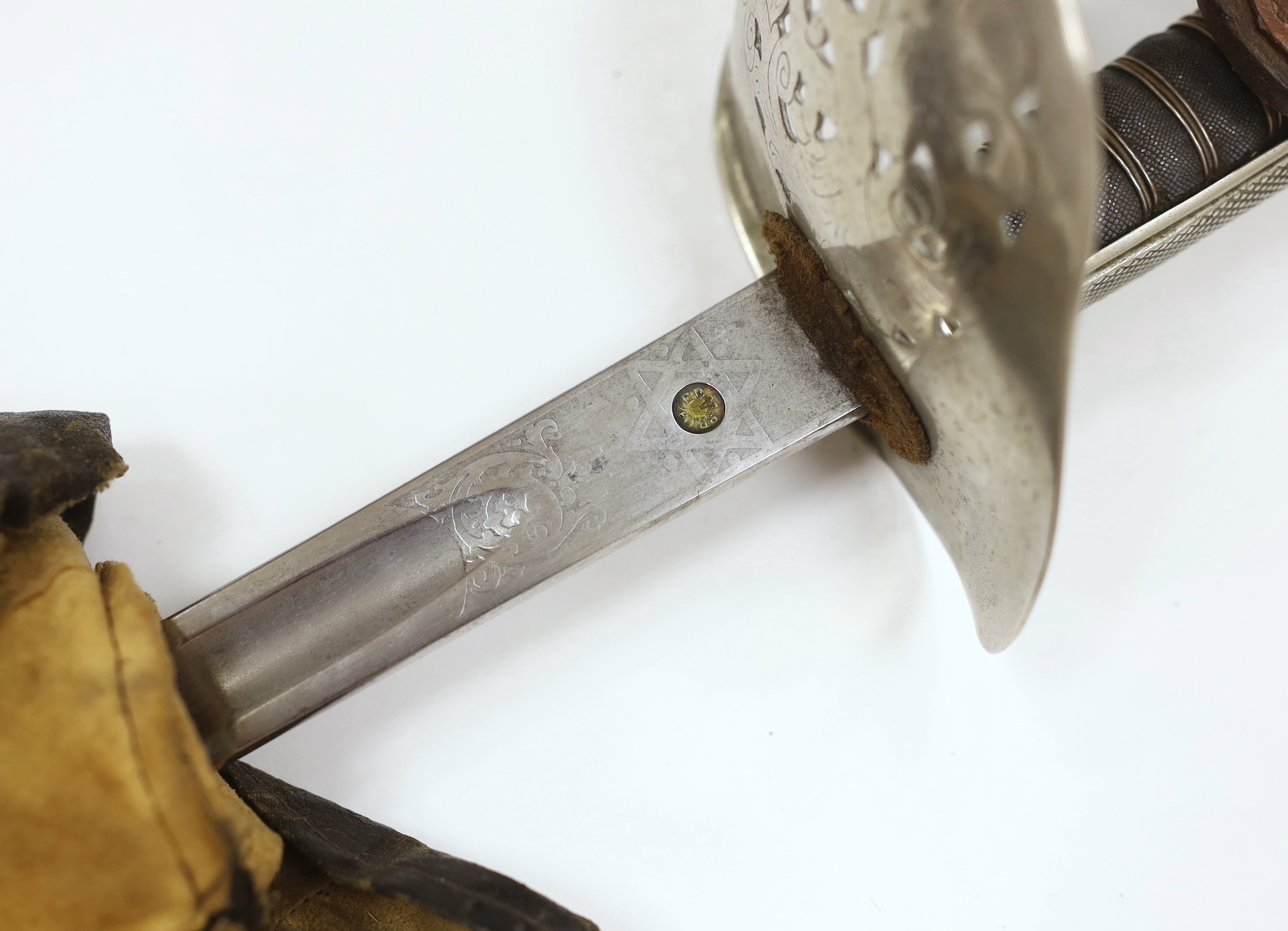 Two Sinhalese daggers and a kukri, a silver inlaid Kirichchiya dagger, together with another in a scabbard with a long pin, another dagger with a wooden handle, a head of a brass inlaid iron pole arm, a George V 1897 pat